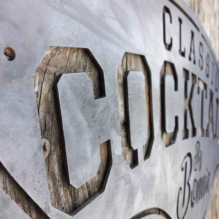 This metal bar sign reads, " Classic Cocktails By Bonnie"