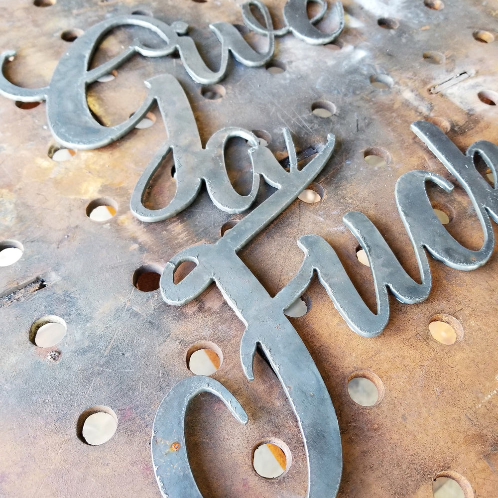 This is a personalized metal sign and reads, "Give a Fuck".
