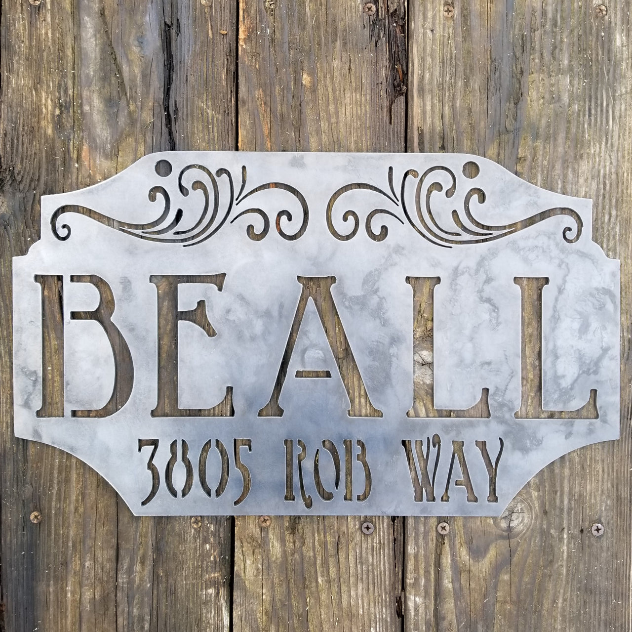 This custom metal address sign is raw steel and reads, "Beall 385 Rob Way"