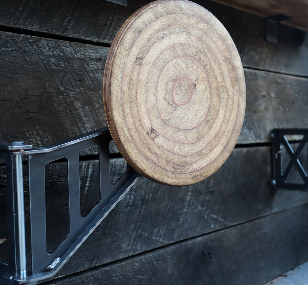 Rectangular cutout swing-away bar stool with wood seat mounted to rustic wall