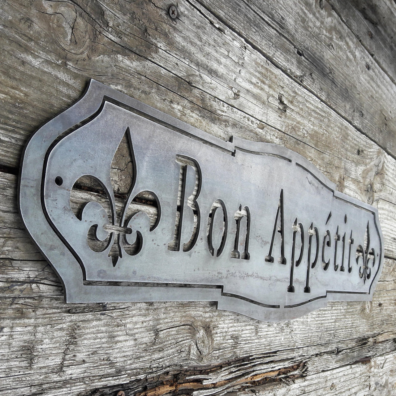 French country, raw steel, metal sign which reads, "Bon Apetit"