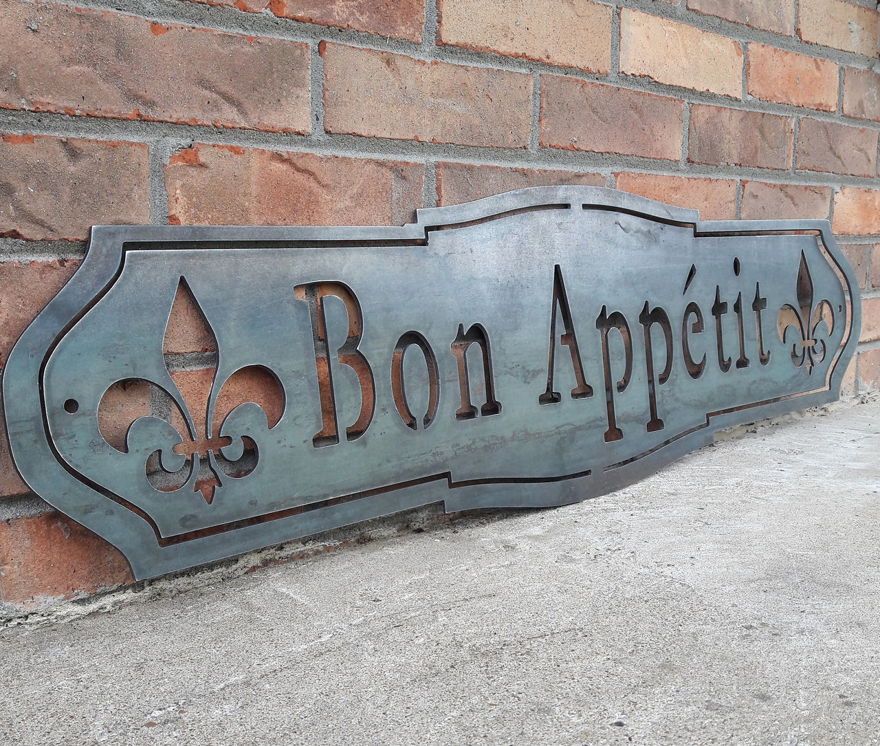 French country, raw steel, metal sign which reads, "Bon Apetit"