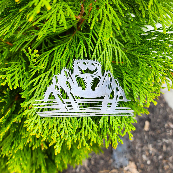 metal ornament with jumping spider cutout