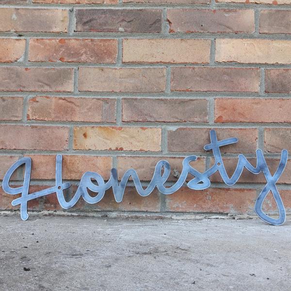 This custom metal sign is a cursive word and reads, "Honesty".