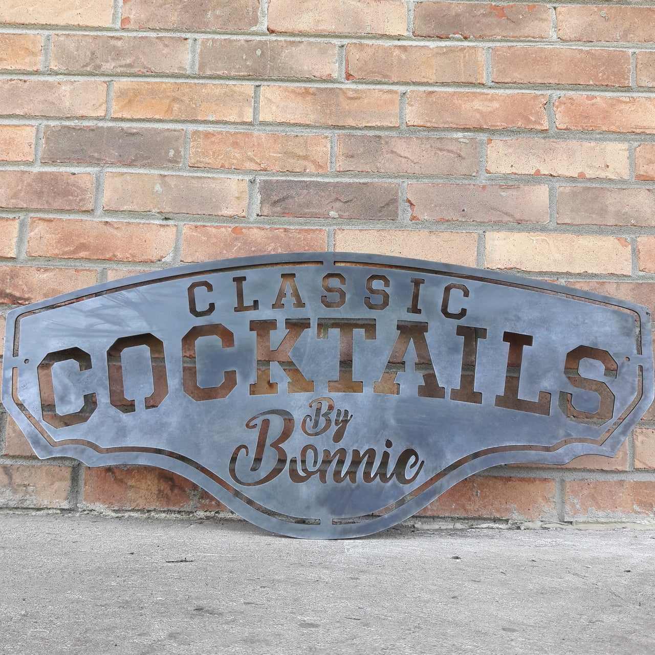 This metal bar sign reads, " Classic Cocktails By Bonnie"