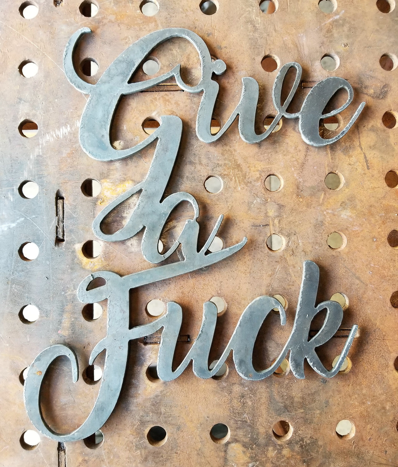 This is a personalized metal sign and reads, "Give a Fuck".