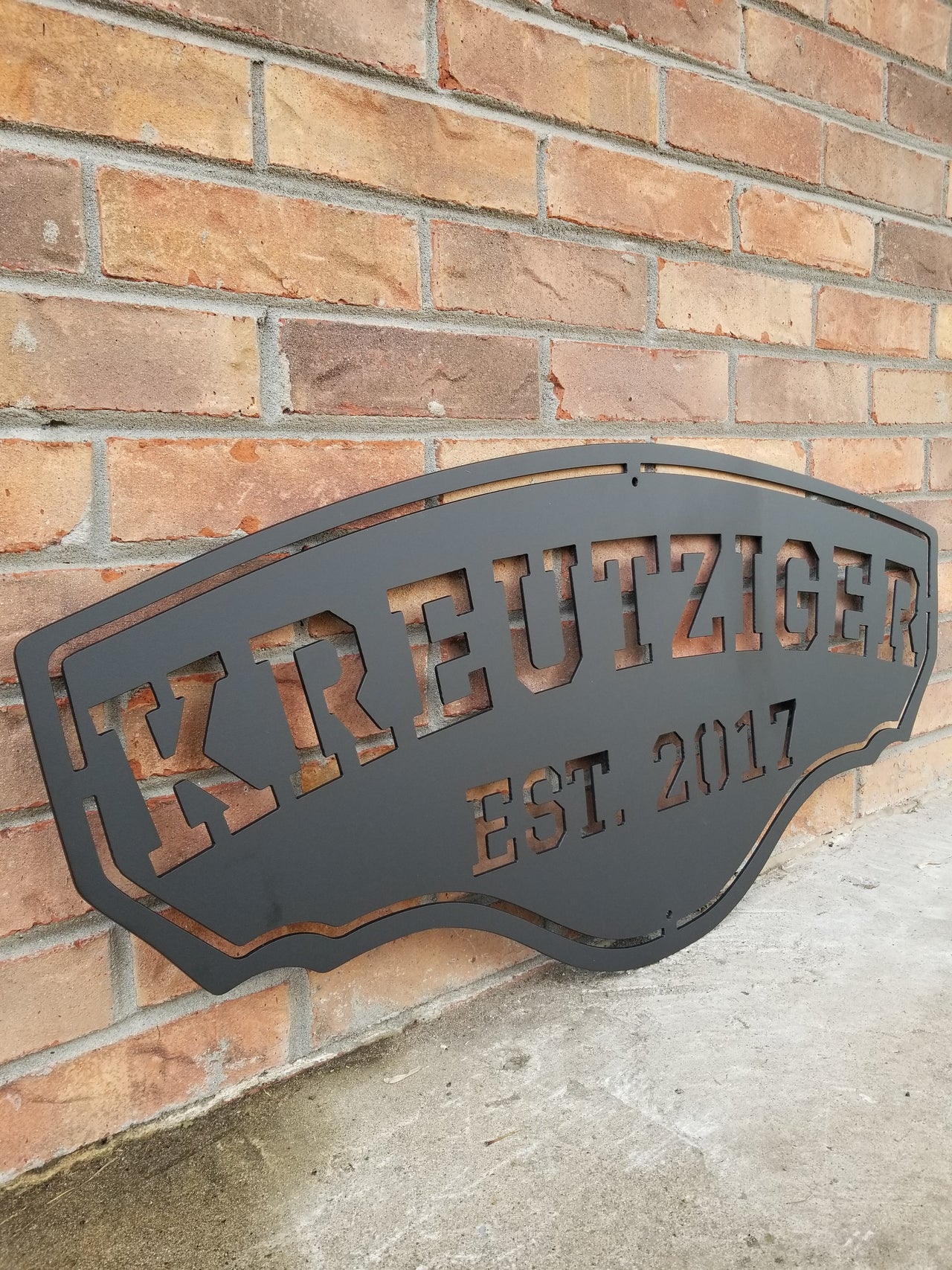 This personalized metal sign reads, "KREUTZIGER Est. 2017".