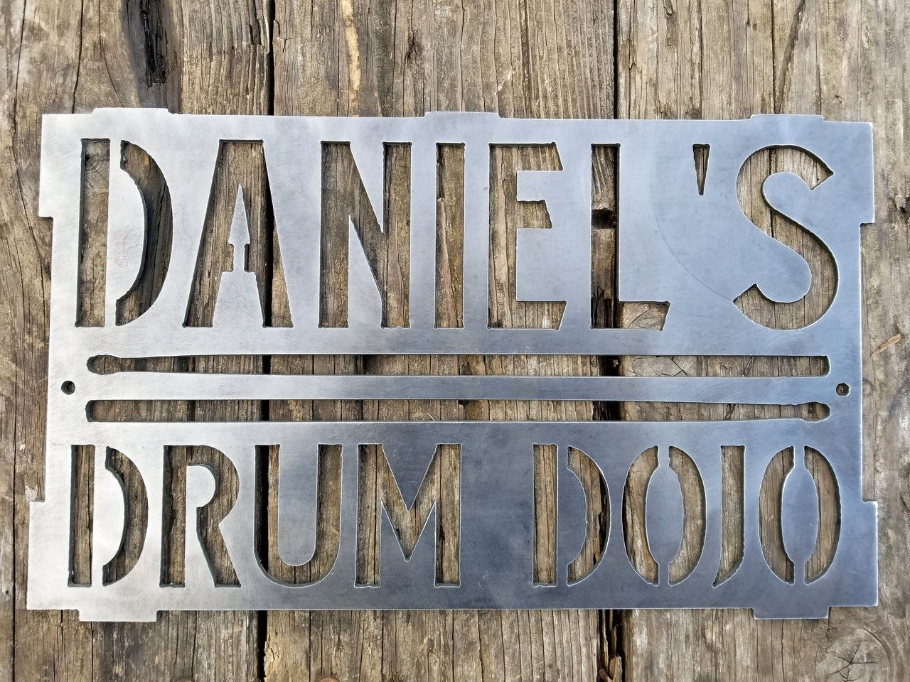 This is a rectangular sign that reads, "Daniel's Drum Dojo".