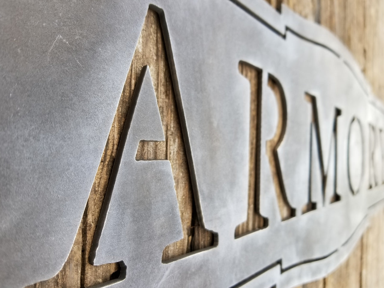 This sign has a classic shape and reads, "ARMORY"