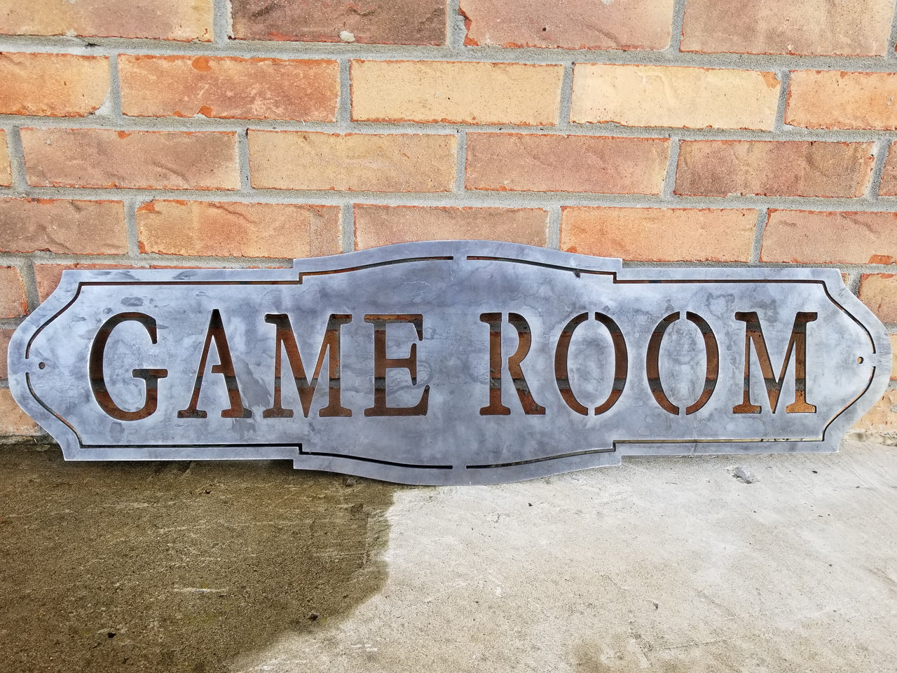 This home decor metal sign reads, "Game Room"