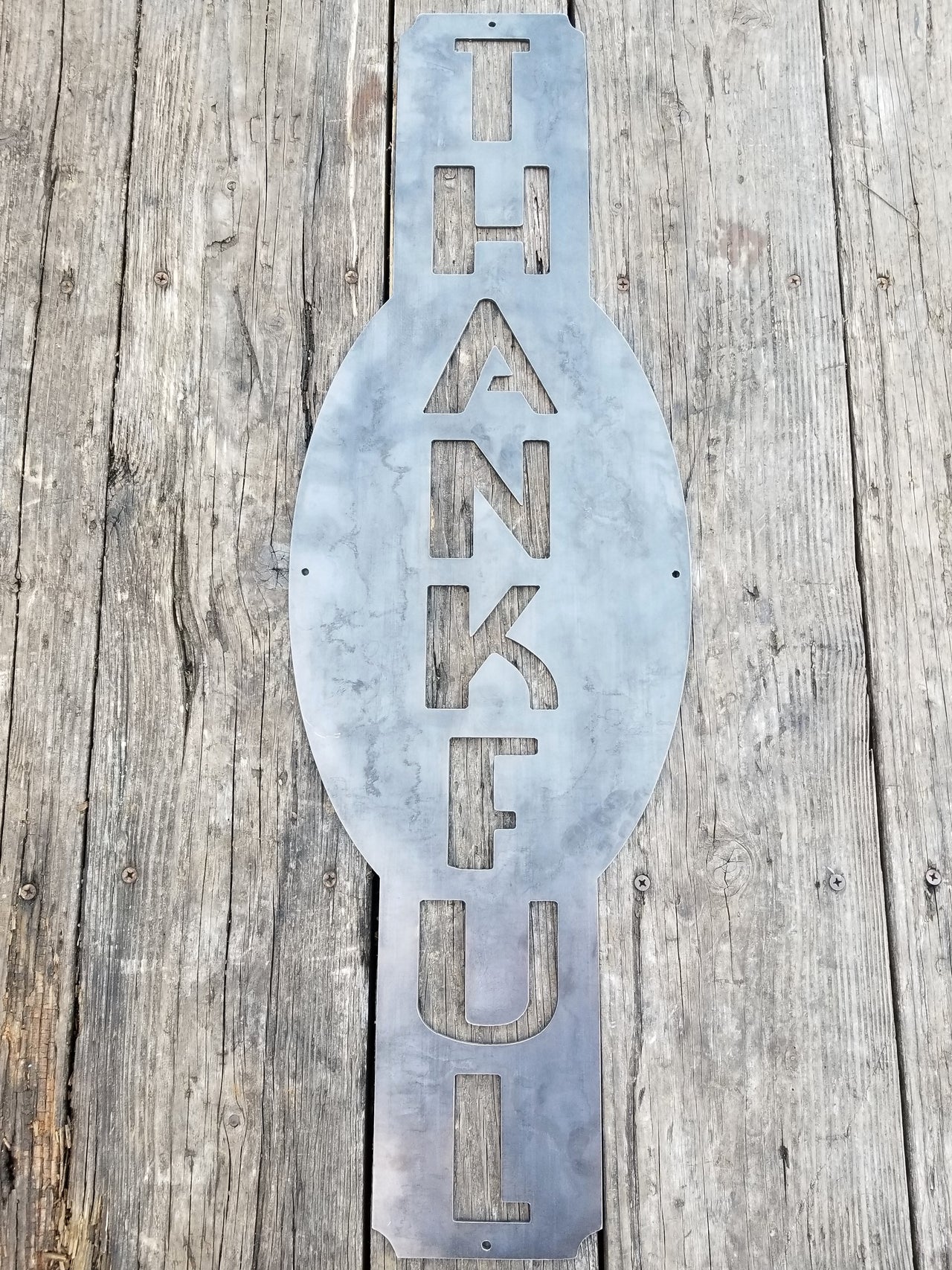 This custom vertical  metal sign reads, "Thankful".