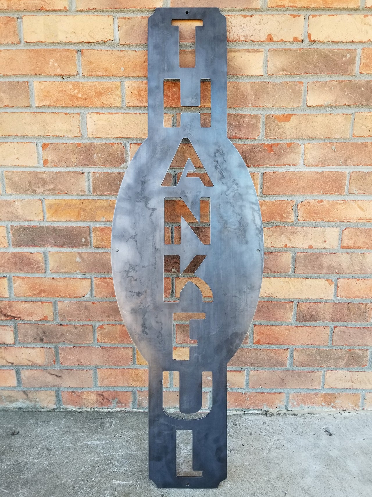 This custom vertical  metal sign reads, "Thankful".