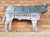 Thumbnail for This is a metal sign in the shape of a cow with the cuts of beef outlined.