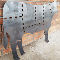 Thumbnail for This is a metal sign in the shape of a cow with the cuts of beef outlined.