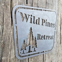 Thumbnail for This sign has a vintage design and depicts a group of trees. It reads, 