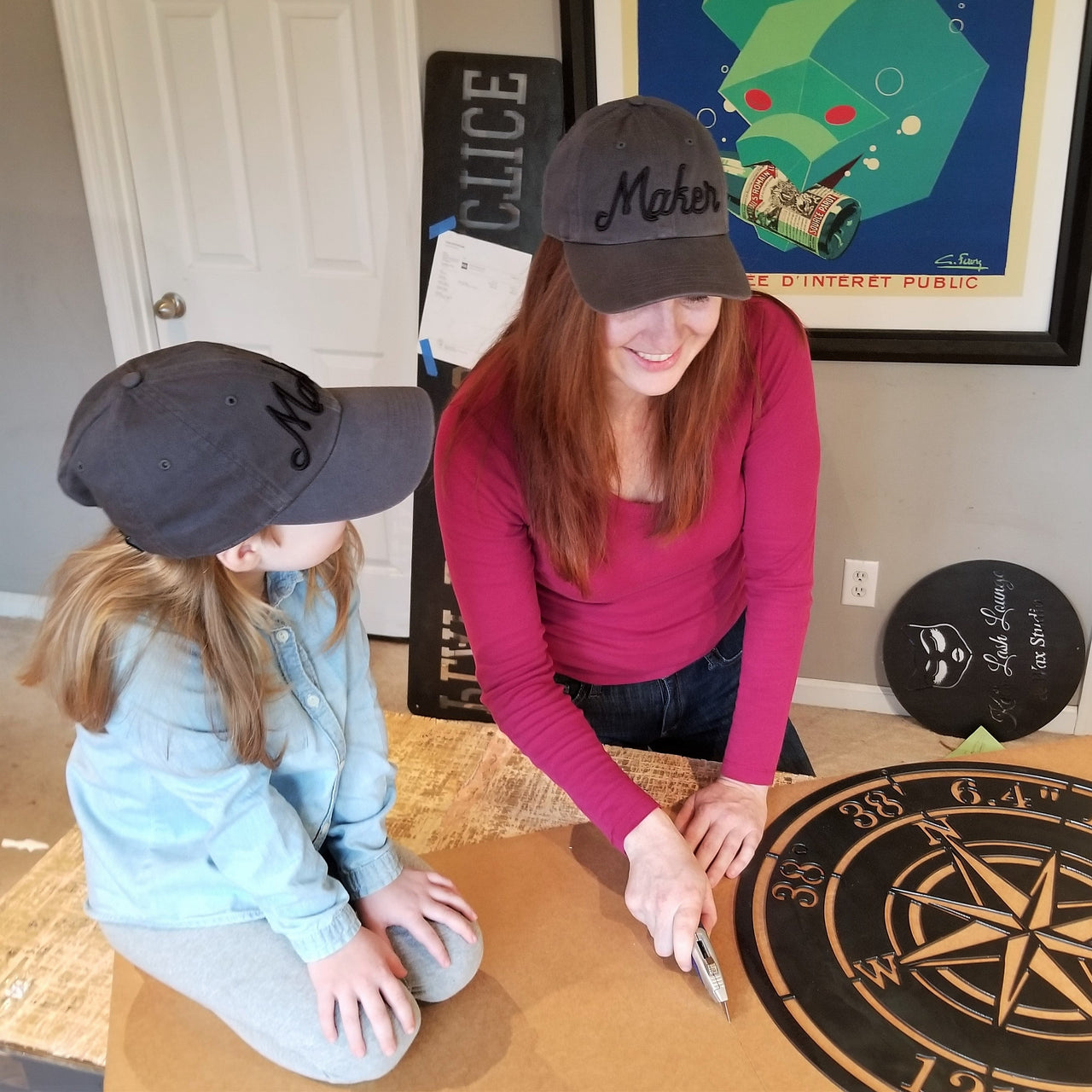 This is an image of one of the owners, Stefanie Heffner, with her daughter preparing a sign for shipment.