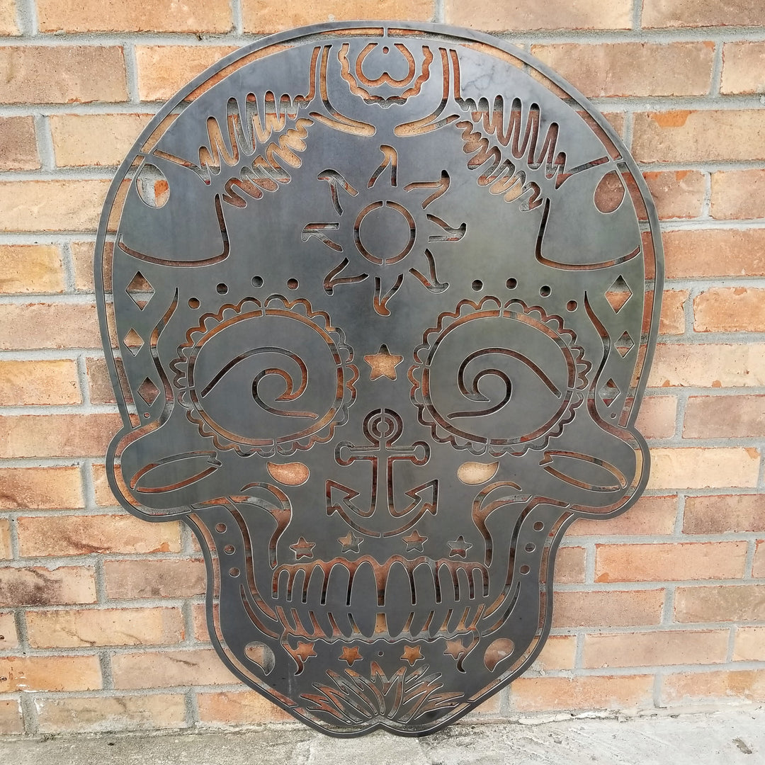 This sign is in the shape of a sugar skull. It is water themed with waves, fish bones, anchors and more.