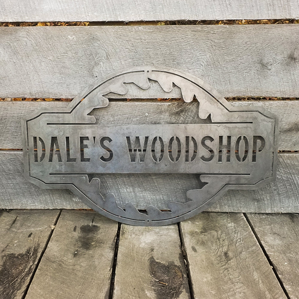 Custom steel saw blade sign engraved with workshop name