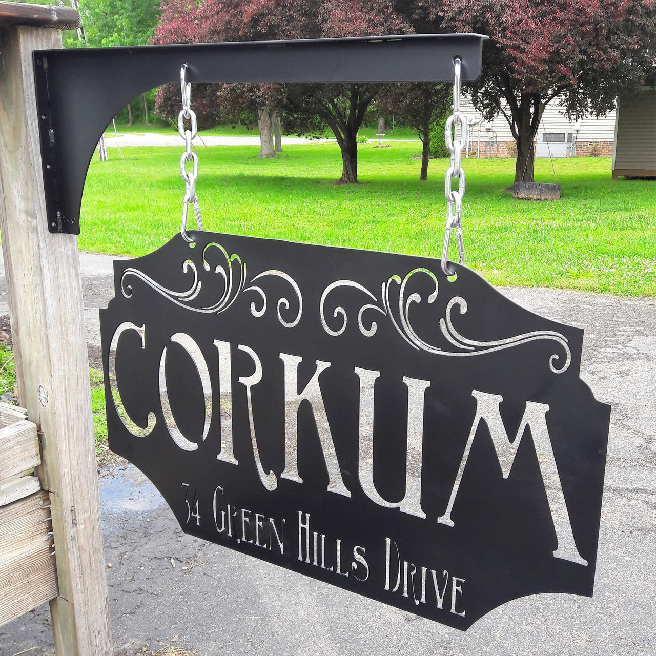 This custom metal sign is Powdercoated and comes with a matching hanging post, silver chain and carabiners. The hanging sign reads, "Corkum in Green Hills Drive". it is an address sign