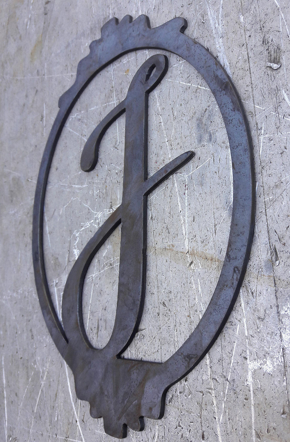 Personalized metal monogram with a border. The sign has a single letter and reads, "F".