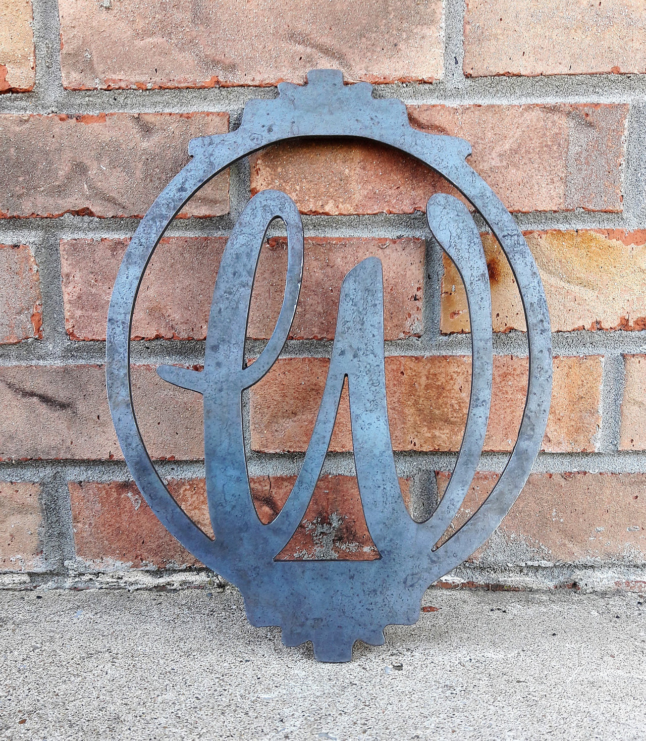 Personalized metal monogram with a border. The sign has a single letter and reads, "W".