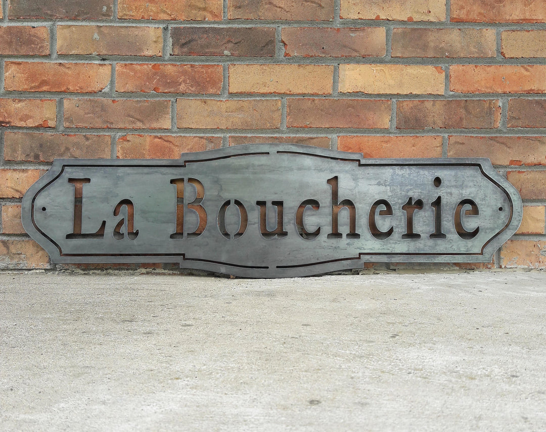 French country, raw steel, metal sign which reads, "La Boucherie"
