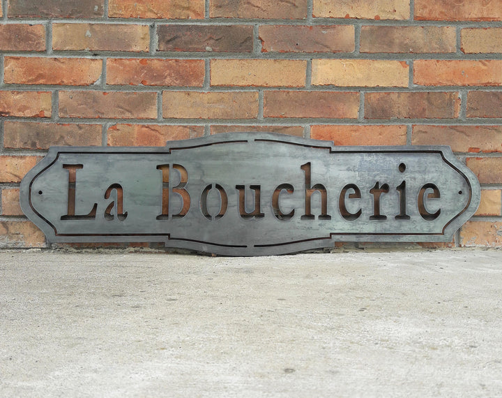 French country, raw steel, metal sign which reads, "La Boucherie"