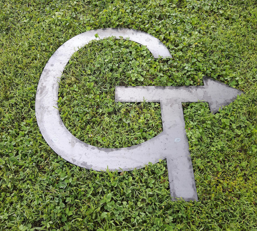 Handmade cattle brand sign with arrow design