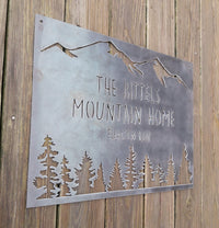 Thumbnail for rectangular sign with a mountain range across the top and a coniferous tree line. There are two lines of text on this sign as well as an elevation.  The sign reads, 