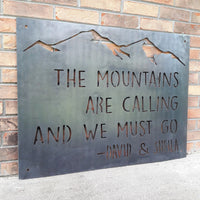 Thumbnail for This Metal sign has a mountain range across the top and features a quote by John Muir. The sign reads, 