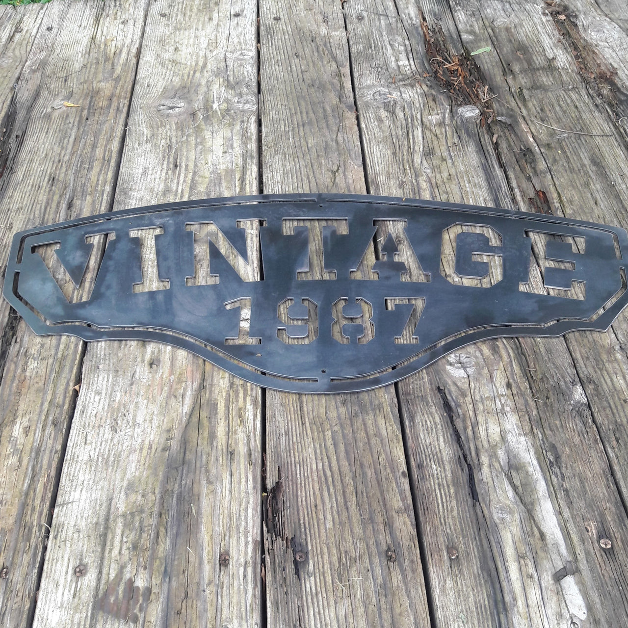 This personalized metal sign reads, "VINTAGE1987".