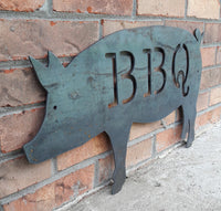 Thumbnail for This is a metal sign in the shape of pig with two 1/4