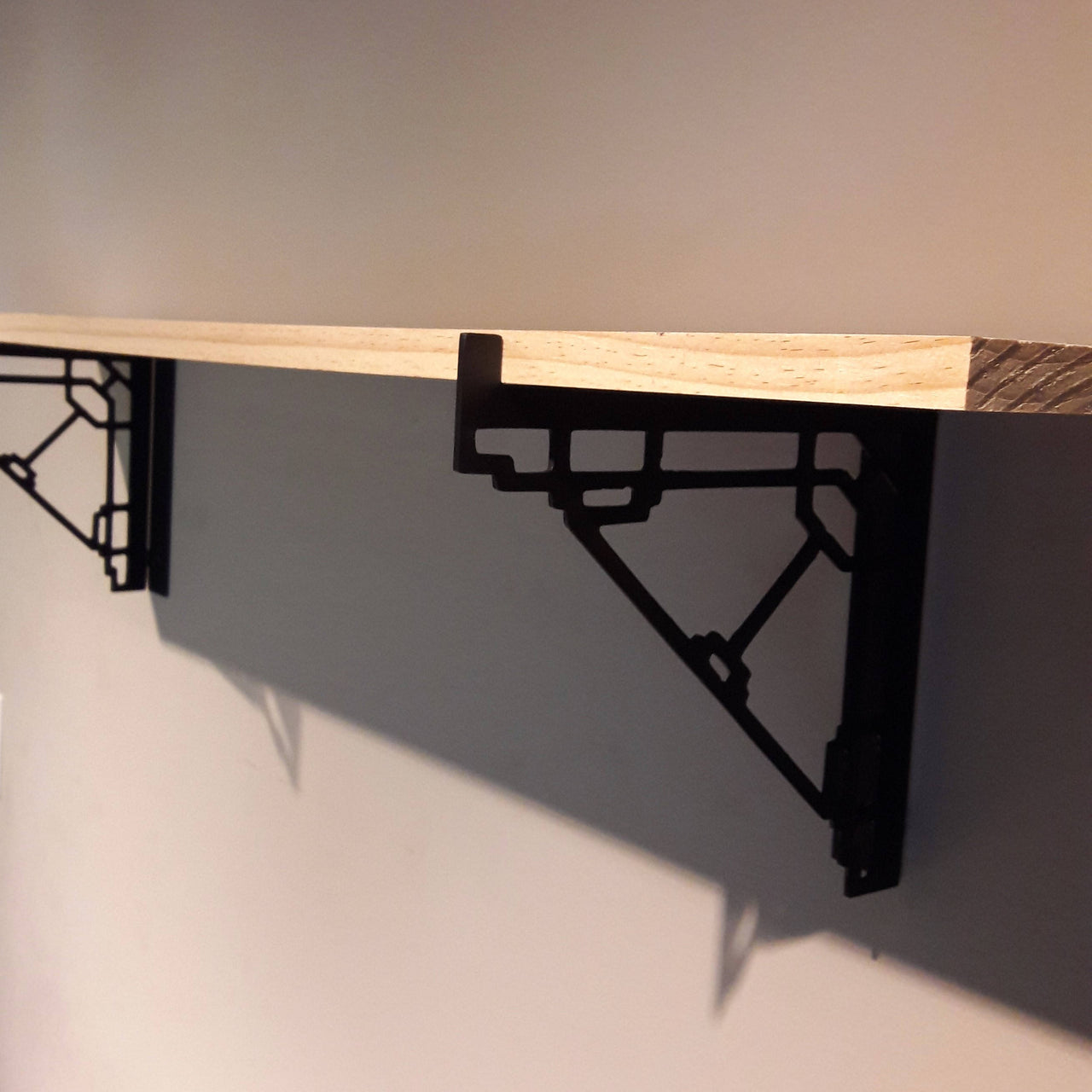 These metal shelf brackets are a contemporary design and fit standard lumber sizes