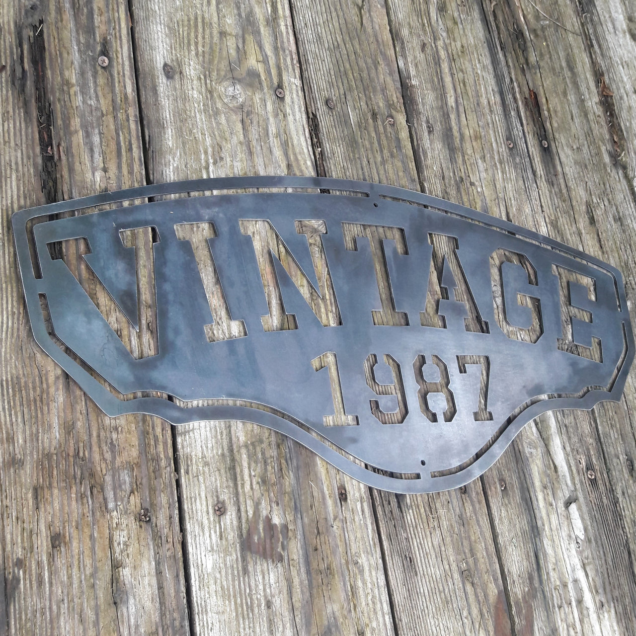 This personalized metal sign reads, "VINTAGE1987".
